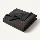 Folded charcoal woven EachPaw backup cover.